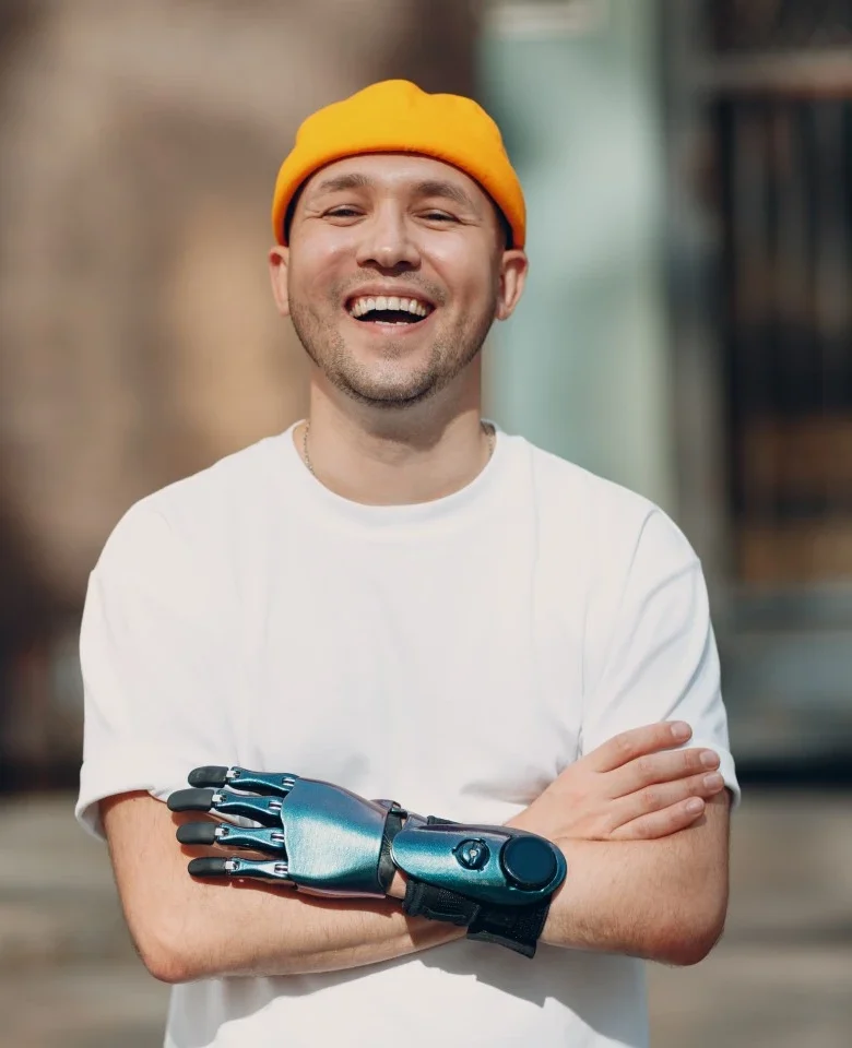 Disabled man with arms crossed smiling at camera