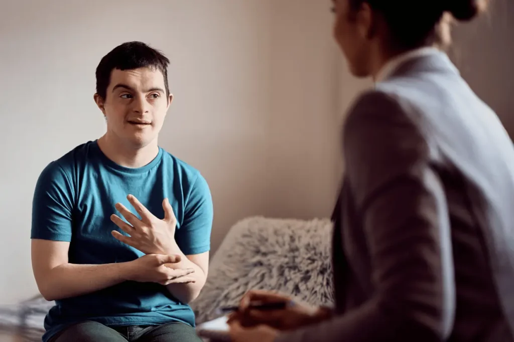 Disabled boy talking with support worker about maximising NDIS plan